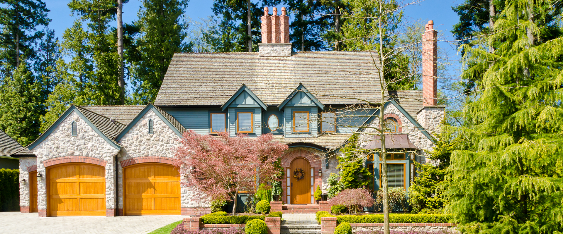 Large stone house with double wooden garage