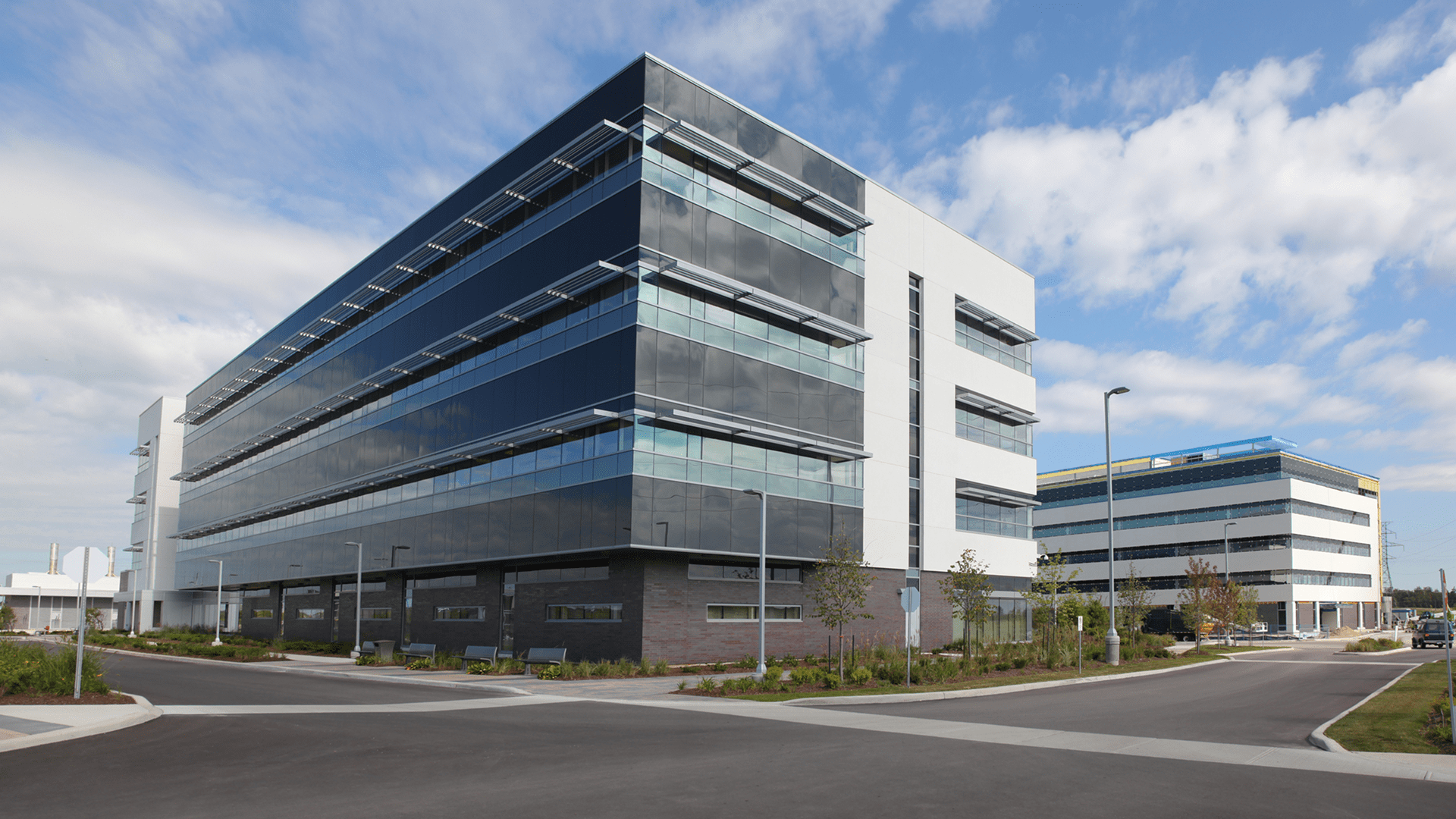 Modern glass office complex under blue sky