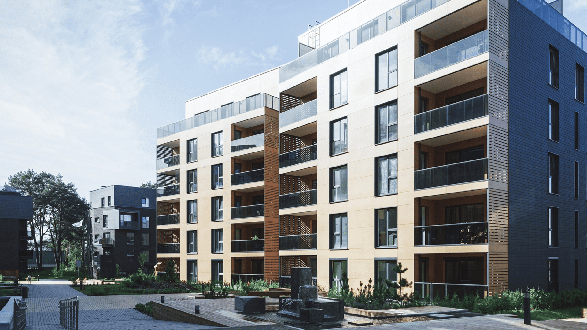 Modern apartment building with balconies and landscaping